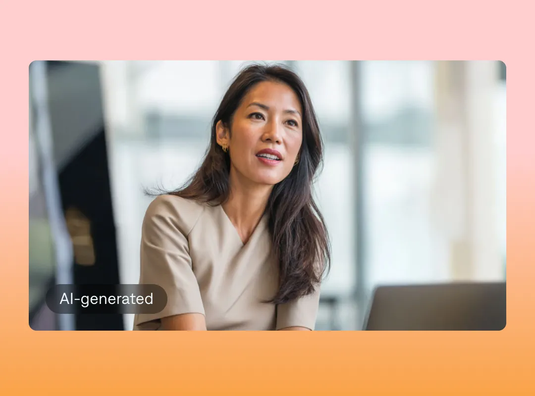Asian woman wearing a beige blouse, in a bright office setting